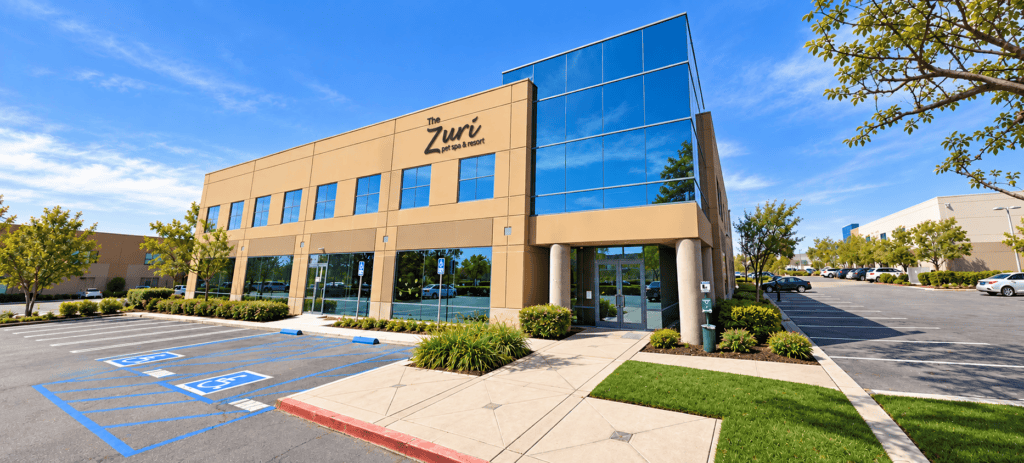Exterior view of Zuri Pet Spa building with glass facade and parking lot.